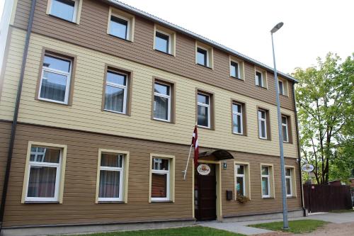 a house with a flag in front of it at Windrose in Liepāja