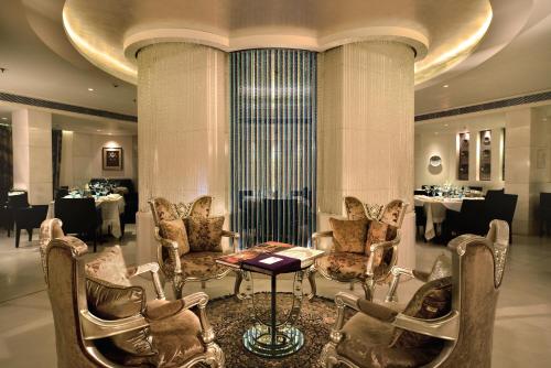 a dining room with chairs and a table and tablesktop at The Golkonda Hotel in Hyderabad