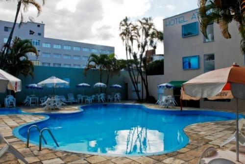 a large swimming pool in front of a building at Hotel Atlantico Sul in Caraguatatuba