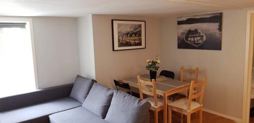 a living room with a couch and a table at Skuteviken Apartments 40 in Bergen