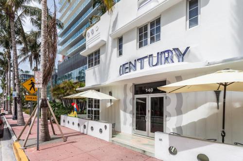 a white building with an entrance to a restaurant at Century Hotel in Miami Beach