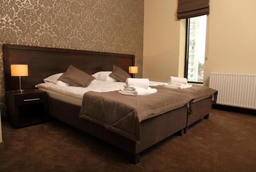 Uma cama ou camas num quarto em Hotel Forum Fitness Spa & Wellness