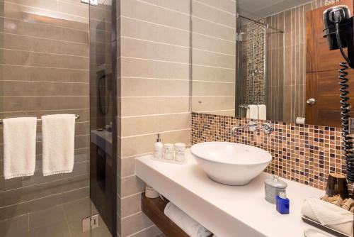 a bathroom with a sink and a mirror at Jetwing Jaffna in Jaffna