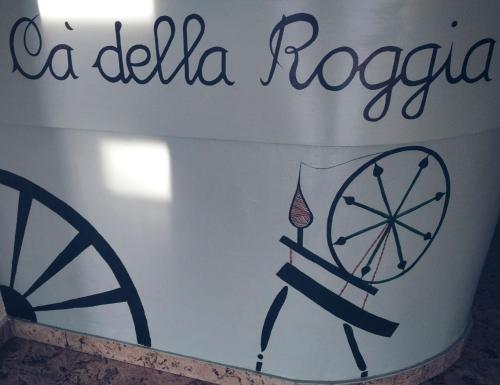 a white bucket with a wheel and a sign on it at Cà della Roggia in Rovereto