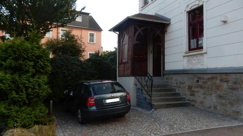 a car parked in front of a house at Ferienwohnung Freiberg, Chemnitzer Straße in Freiberg