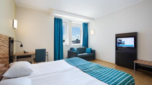 A bed or beds in a room at Hestia Hotel Seaport Tallinn