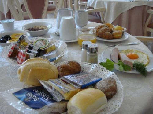 a table with a plate of breakfast food on it at Hotel Royal Plaza in Rimini