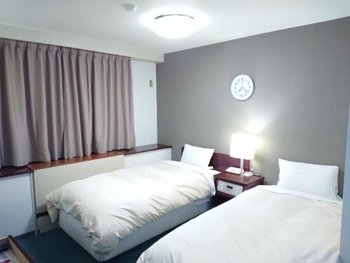 Llit o llits en una habitació de Hotel Crown Hills Imabari