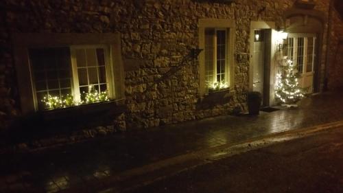 a house with christmas lights in the windows at night at Gîte du Soleil in Anhée