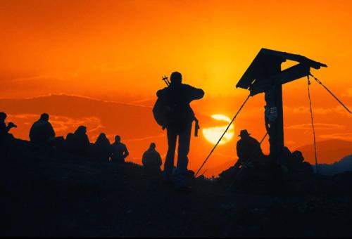 eine Gruppe von Menschen, die bei Sonnenuntergang auf einem Berg stehen in der Unterkunft Ferienwohnungen am Lärchenweg in Sexten