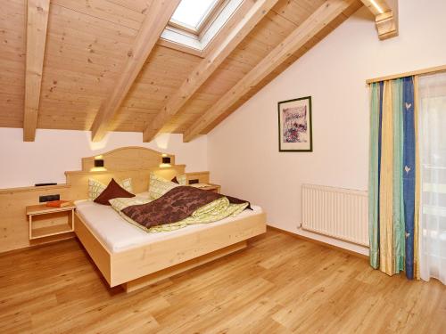 a bedroom with a bed and a wooden ceiling at Gästehaus Renate in Längenfeld