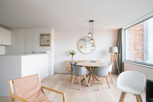 a kitchen and dining room with a table and chairs at Skyline Flats Gent in Ghent