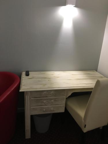 un escritorio de madera con una luz en la parte superior en Hotel Victor Hugo, en Dijon