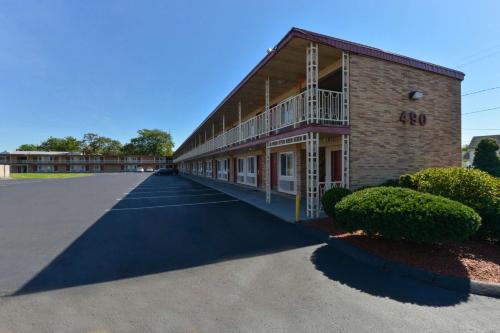 a building with a balcony on the side of it at Economy Inn in East Hartford