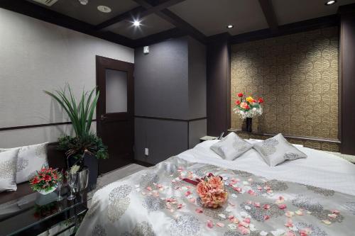 a bedroom with a bed with flowers on it at Restay Okayama (Adult Only) in Okayama