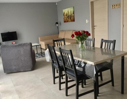 uma mesa de jantar com um vaso de flores em Rentalis Flat em Liège