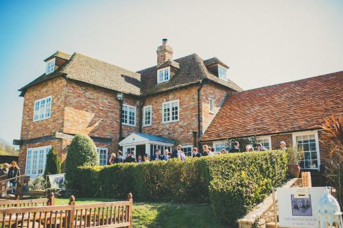 a group of people standing in front of a building at Master Builder's House Hotel in Beaulieu