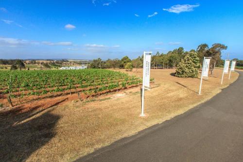 a row of signs on the side of a road at Verona Vineyard Cottage in Pokolbin