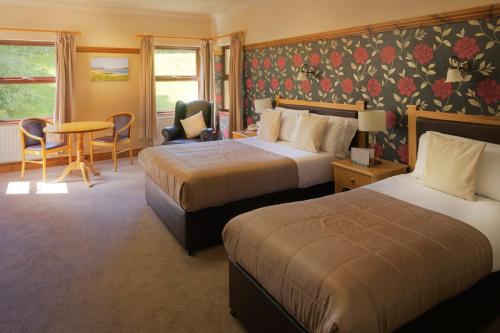 A bed or beds in a room at Silver Tassie Hotel & Spa