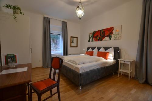 Apartment Graz-Ulrichsbrunn, free parking في غراتس: غرفة نوم بسرير ومكتب وكرسي