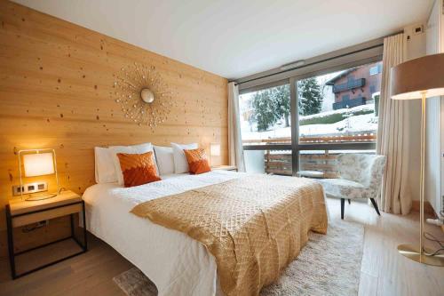 En eller flere senge i et værelse på Megeve Appartment – Vacances d'hiver – АЕ102