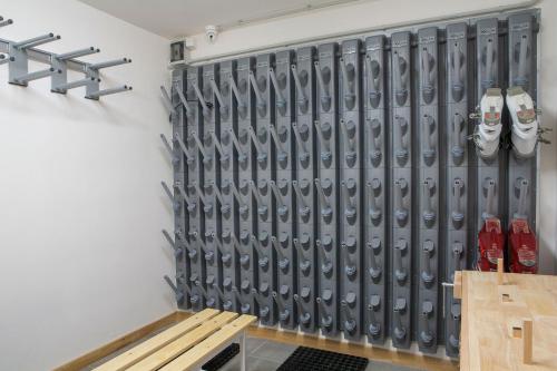 a hockey locker room with a bench in front of it at Residence Aspen in Arabba