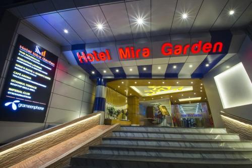 a building with stairs in front of a mica mine garden at Hotel Mira Garden in Sylhet