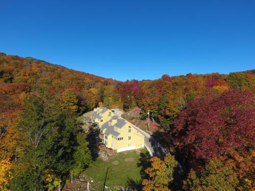 an aerial view of a house in the woods at Luxurious Trailside Village One Bedroom Condo #1 in Killington