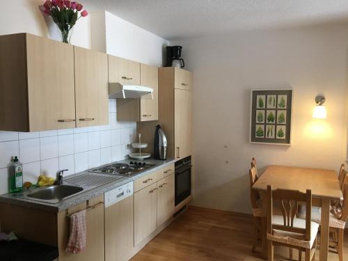 a kitchen with a sink and a table with a dining room at Appartement Gurgl in Obergurgl