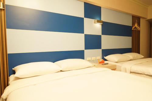 um quarto com uma parede listrada em azul e branco em Ying Dai Hotel em Tainan