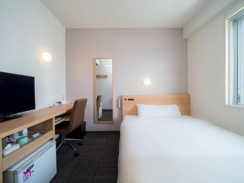 Postelja oz. postelje v sobi nastanitve Super Hotel Takamatsu Tamachi