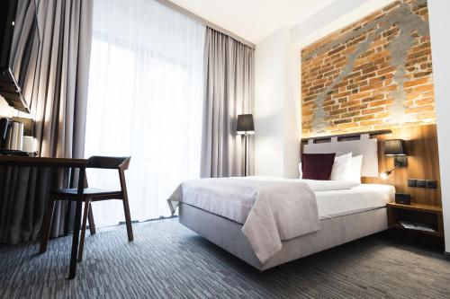 Кровать или кровати в номере Best Western Hotel Mariacki Katowice