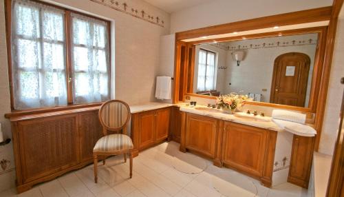 a bathroom with a sink and a mirror and a chair at Tenuta Cusmano in Grottaferrata