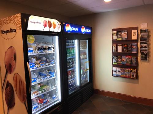 two refrigerators in a store with food in them at Chateau Saint John Trademark Collection by Wyndham in Saint John