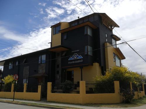 un edificio negro y amarillo al lado de una calle en Puerto Austral, en Puerto Varas