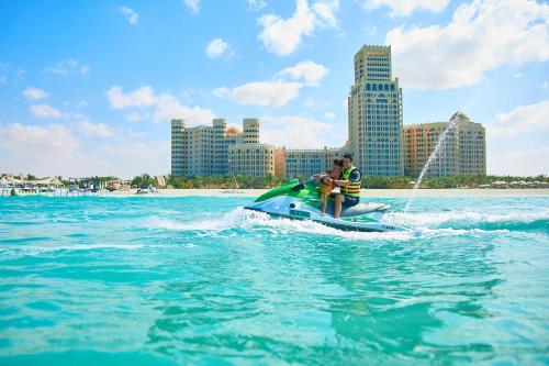 2 personnes sur un jet ski dans l'eau dans l'établissement Al Hamra Residence, à Ras al Khaimah