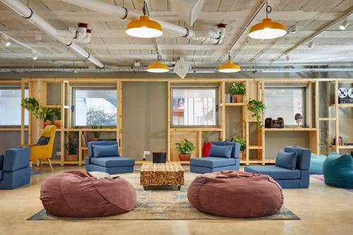 une grande chambre avec des chaises bleues et une table dans l'établissement Unite Hostel Barcelona, à Barcelone