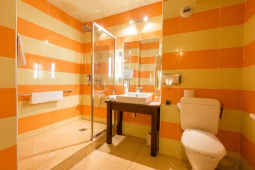 a bathroom with a toilet and a sink at Hôtel Provence in Draguignan