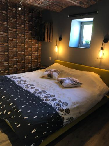 a bedroom with a bed with two pillows on it at Gîte de Corbion Loft1 in Ciney