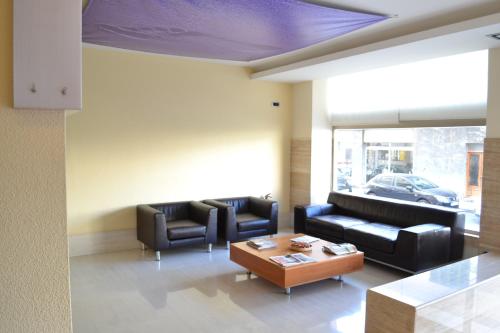 a living room with couches and a coffee table at Hotel Marfil in San Antonio