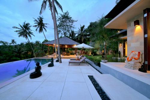 a house with a swimming pool next to a house at Villa Marley in Senggigi 