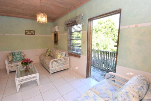 a living room with a couch and a table at The Sugar Apple Lodging in Harbour Island