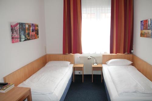 เตียงในห้องที่ Hotel Römerhof Hanau by Trip Inn