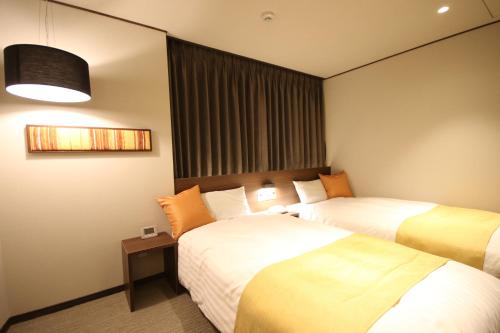 A bed or beds in a room at Kita Hotel