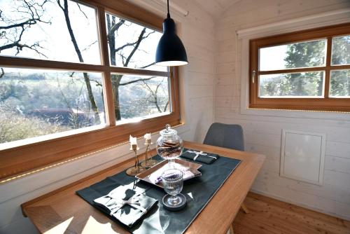 a dining room with a table and a window at Tiny House Dreischwesternherz in Trier