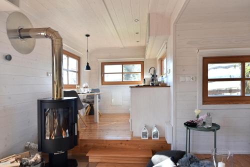 a living room with a fireplace in a tiny house at Tiny House Dreischwesternherz in Trier