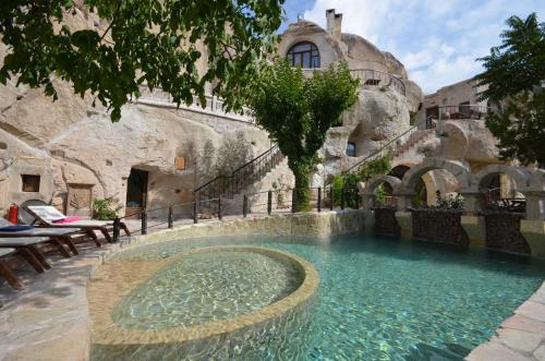 a large swimming pool in a stone building at Cappadocia Gamirasu Cave Hotel in Urgup