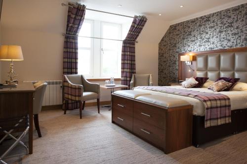 A bed or beds in a room at Cruachan Hotel