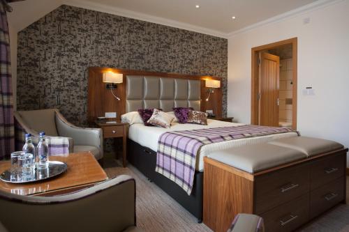 A bed or beds in a room at Cruachan Hotel