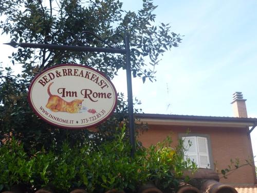 a sign for a firm rome restaurant in front of a building at Inn Rome B&B in Ciampino